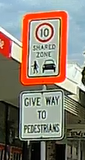 Reflective shared zone and give way to pedestrians signs in Redcliffe, QLD.png