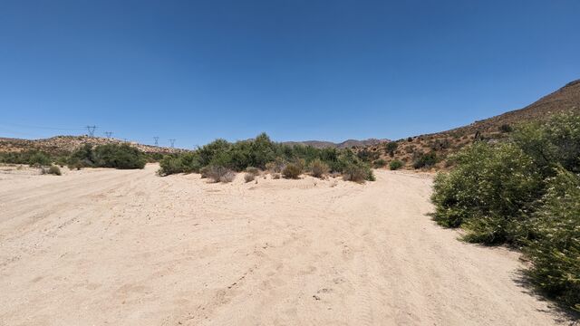 A photo of a wadi in California with scrub